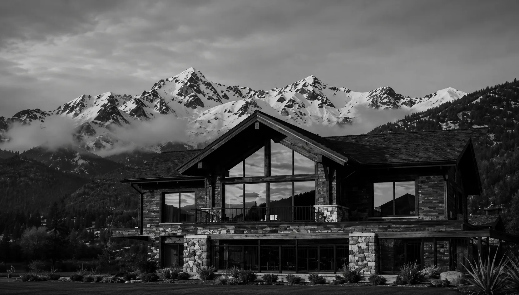 Modern mountain lodge beneath snowy peaks